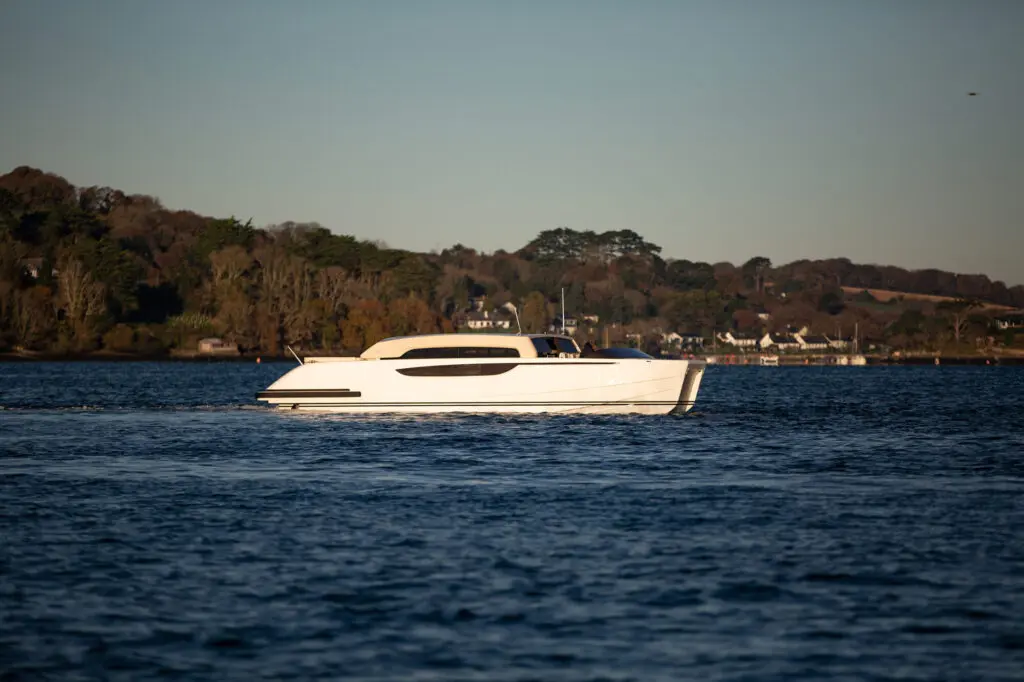 Limousine Catamaran Tender cruising starboard from far