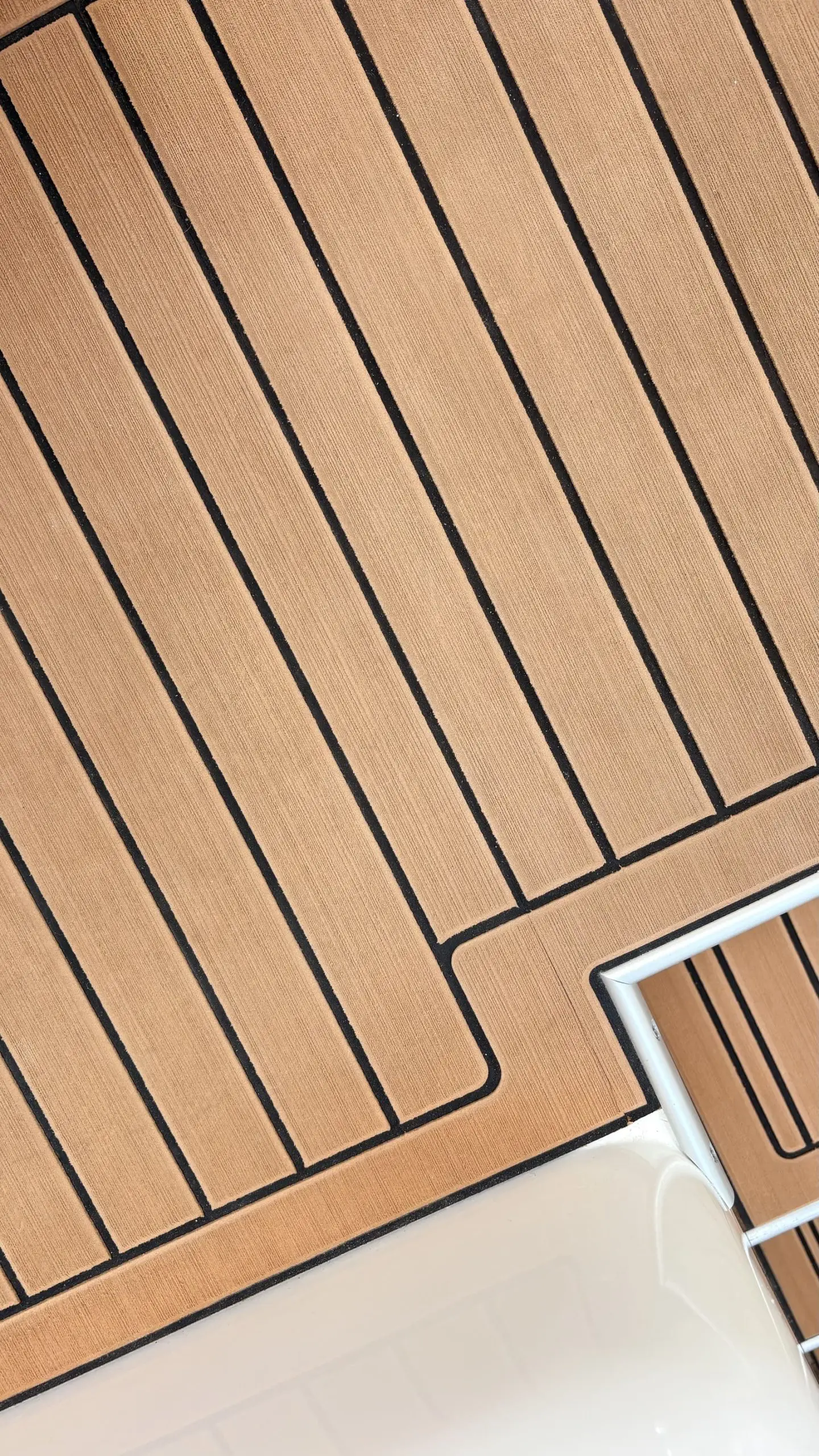 Close up of clean teak decking with tight caulking lines on a Sydney boat