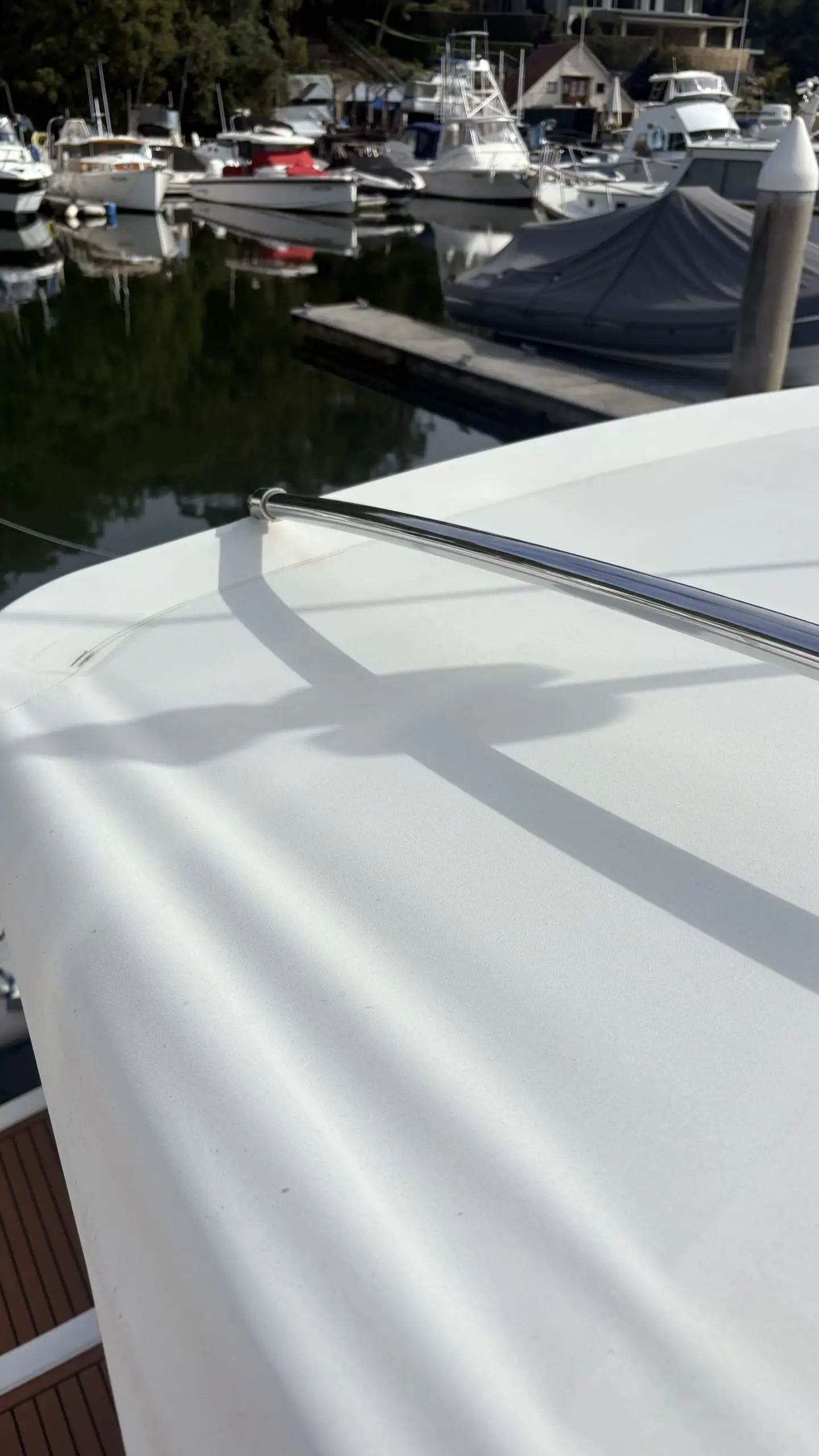 Gloss white foredeck and polished stainless rail after an exterior boat detail in Sydney