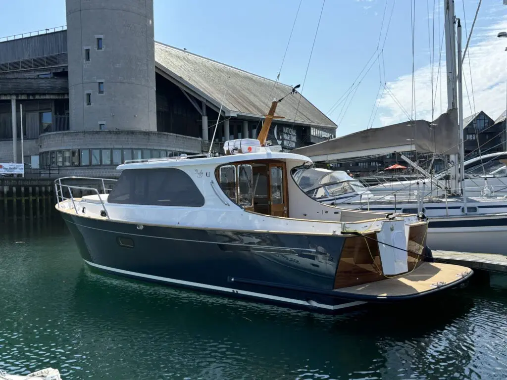 Duchy 35 Laila moored alongside a pontoon showing her grey hull and teak trim