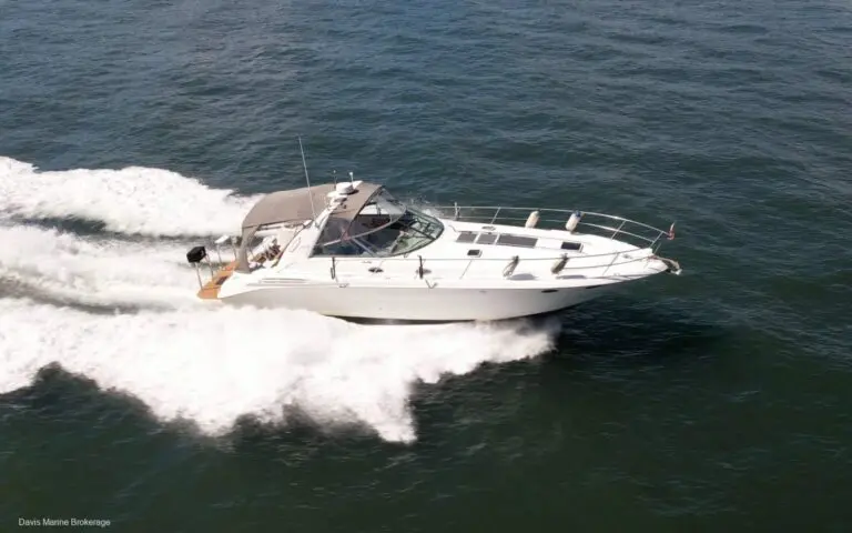 1999 Sea Ray 400 Sundancer sports cruiser underway with bimini up, sold by Davis Marine Brokerage