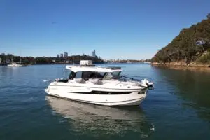 2021 Parker 790 Explorer at anchor on Sydney Harbour with the city skyline behind, sold by Davis Marine Brokerage