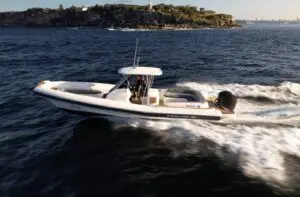 Mar.Co 35 R-Evolution underway on Sydney Harbour, bow quarter view with the T-top and navy tube band
