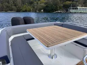 Aft cockpit of the Mar.Co 35 R-Evolution with the teak-topped electric telescopic dining table
