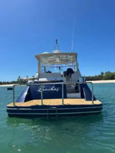 Stern view of the Chris-Craft Roamer 43 Heritage at anchor showing the aft deck and transom