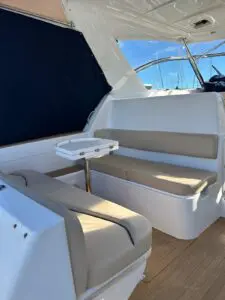 Cockpit seating and table under the hardtop of the Chris-Craft Roamer 43 Heritage