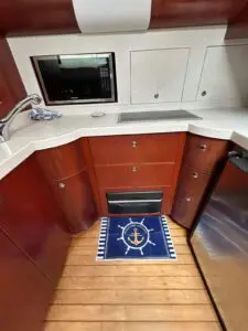 Galley of the Chris-Craft Roamer 43 Heritage with Corian worktop and timber cabinetry
