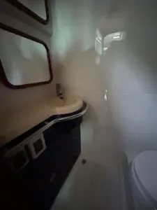 Master bathroom of the Chris-Craft Roamer 43 with vanity and Vacuflush toilet
