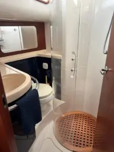 Master ensuite of the Chris-Craft Roamer 43 with shower stall and teak grate