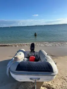 AB inflatable tender with Tohatsu outboard from the Chris-Craft Roamer 43 on the beach