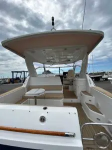 Cockpit of the Chris-Craft Roamer 43 Heritage looking forward under the hardtop at the marina