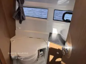 2020 Jeanneau Merry Fisher 895 enclosed bathroom with toilet and basin