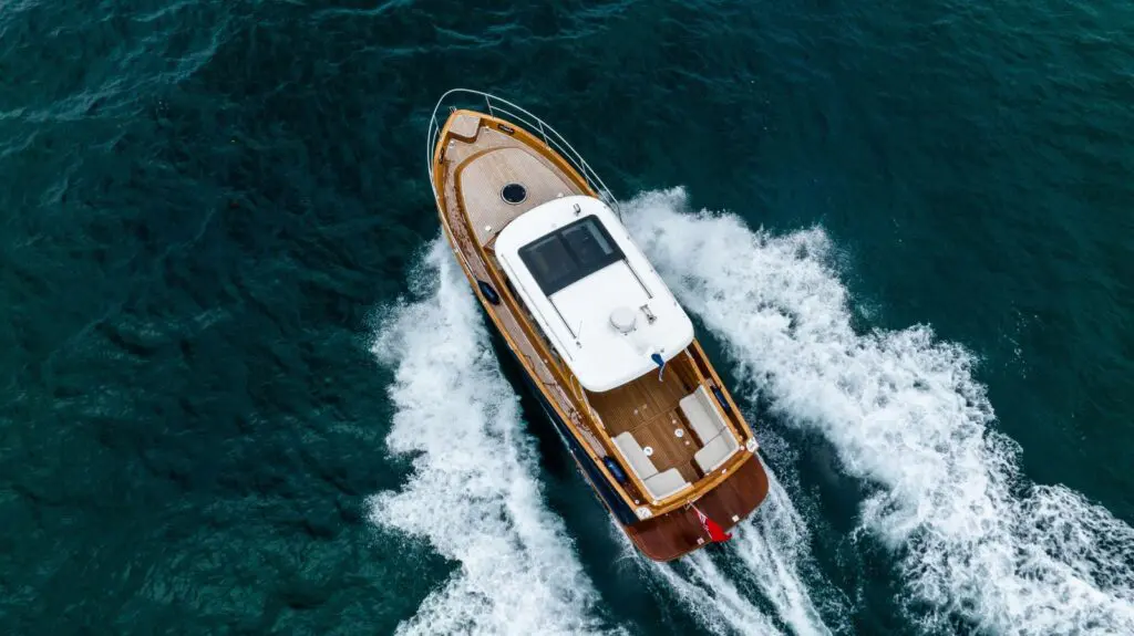 Duchy 35 seen directly from above at speed, showing teak decks, white hardtop and cockpit seating