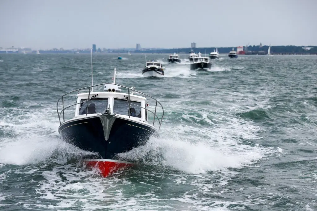 Duchy 35 motor launch at the head of the Cockwells fleet crossing the Solent during the 2025 Owners' Rally