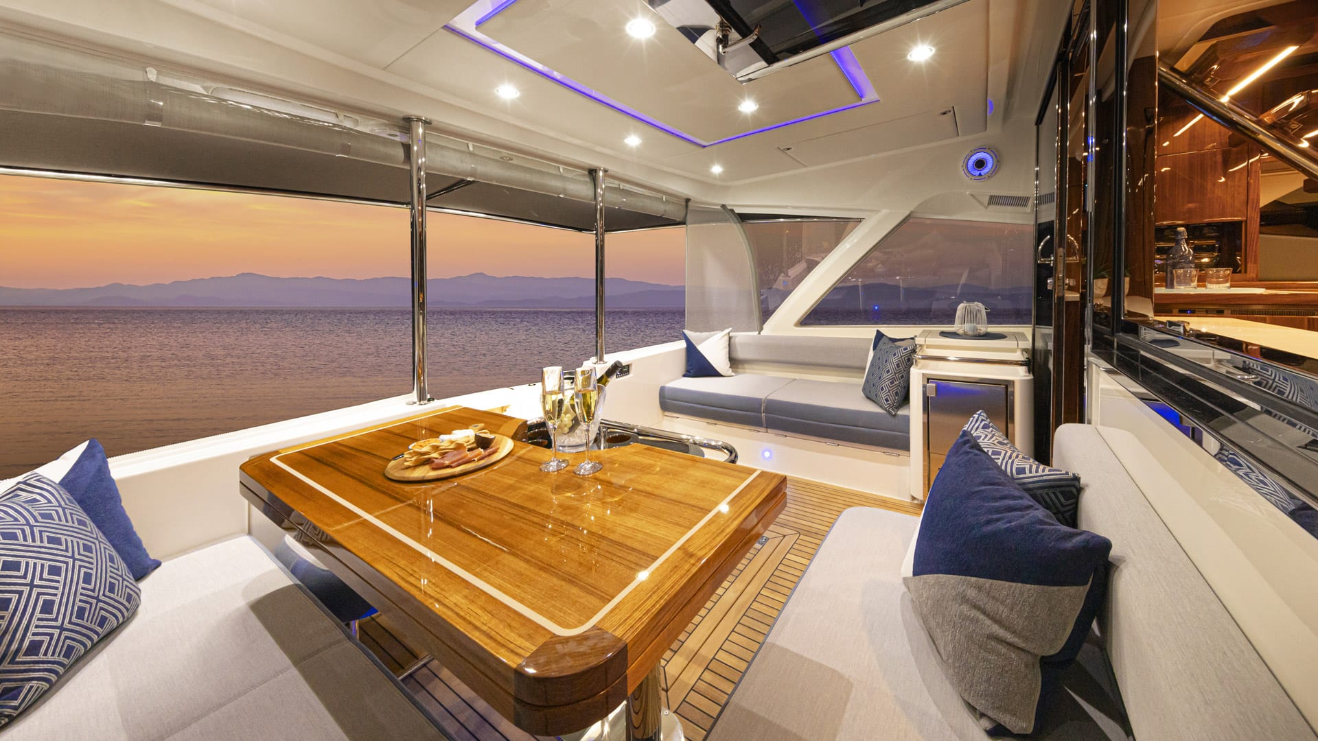 Cockpit and saloon of a Riviera 64 Sports Motor Yacht at dusk