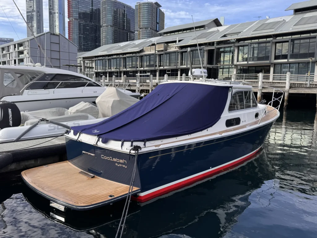 Duchy 27 Coolabah moored at Pyrmont, Sydney, with the city skyline behind