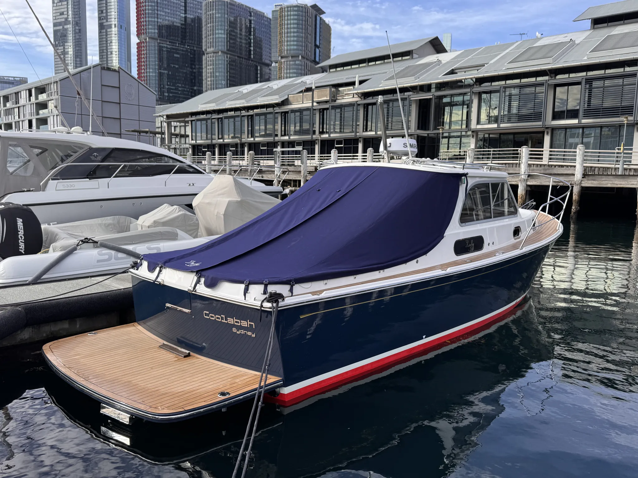 Motor launch moored at a Sydney berth, illustrating the holding costs of an unsold boat