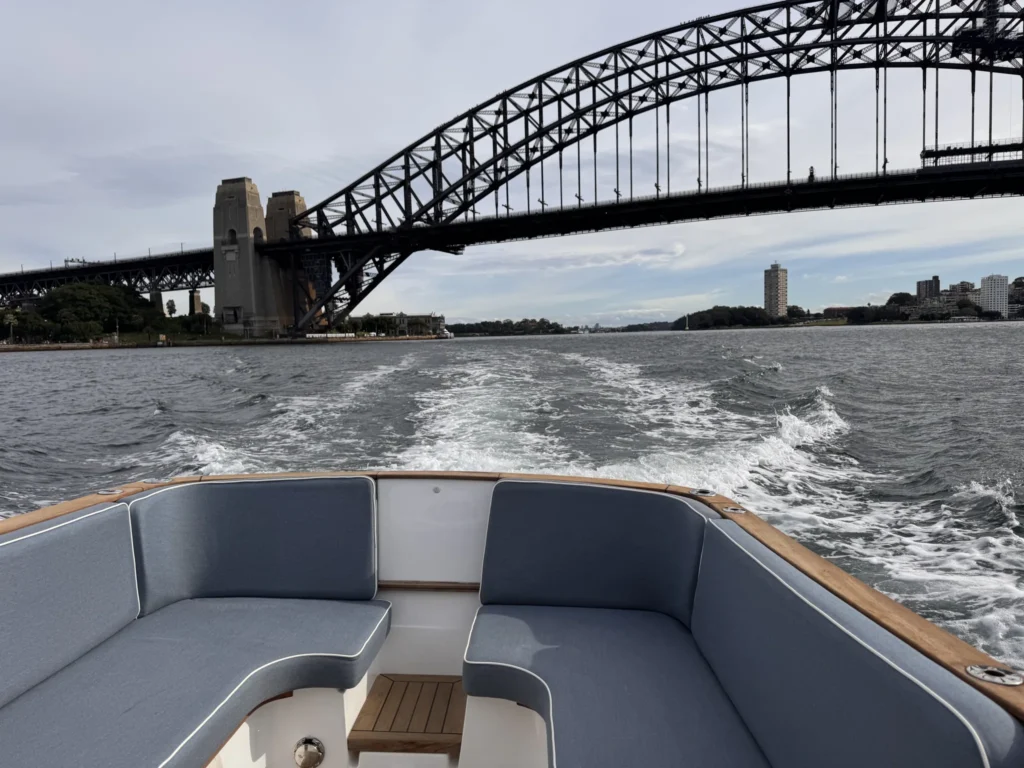 Duchy 27 motor launch Coolabah cruising past the Sydney Harbour Bridge