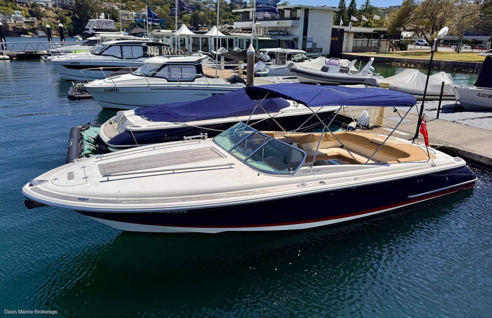 2008 Chris-Craft Corsair 28 with dark blue hull and blue bimini alongside a Sydney marina, sold by Davis Marine Brokerage