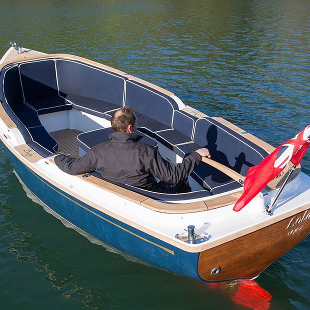 Helm and cockpit of the Cockwells Duchy 21 open day boat with an owner at the wheel