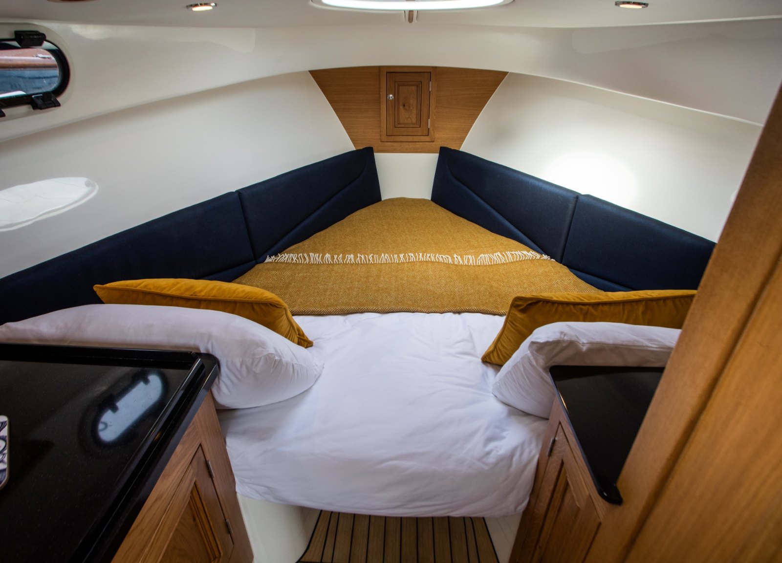 Cabin of the Cockwells Duchy 25 with the V-berth made up as a double bed for two