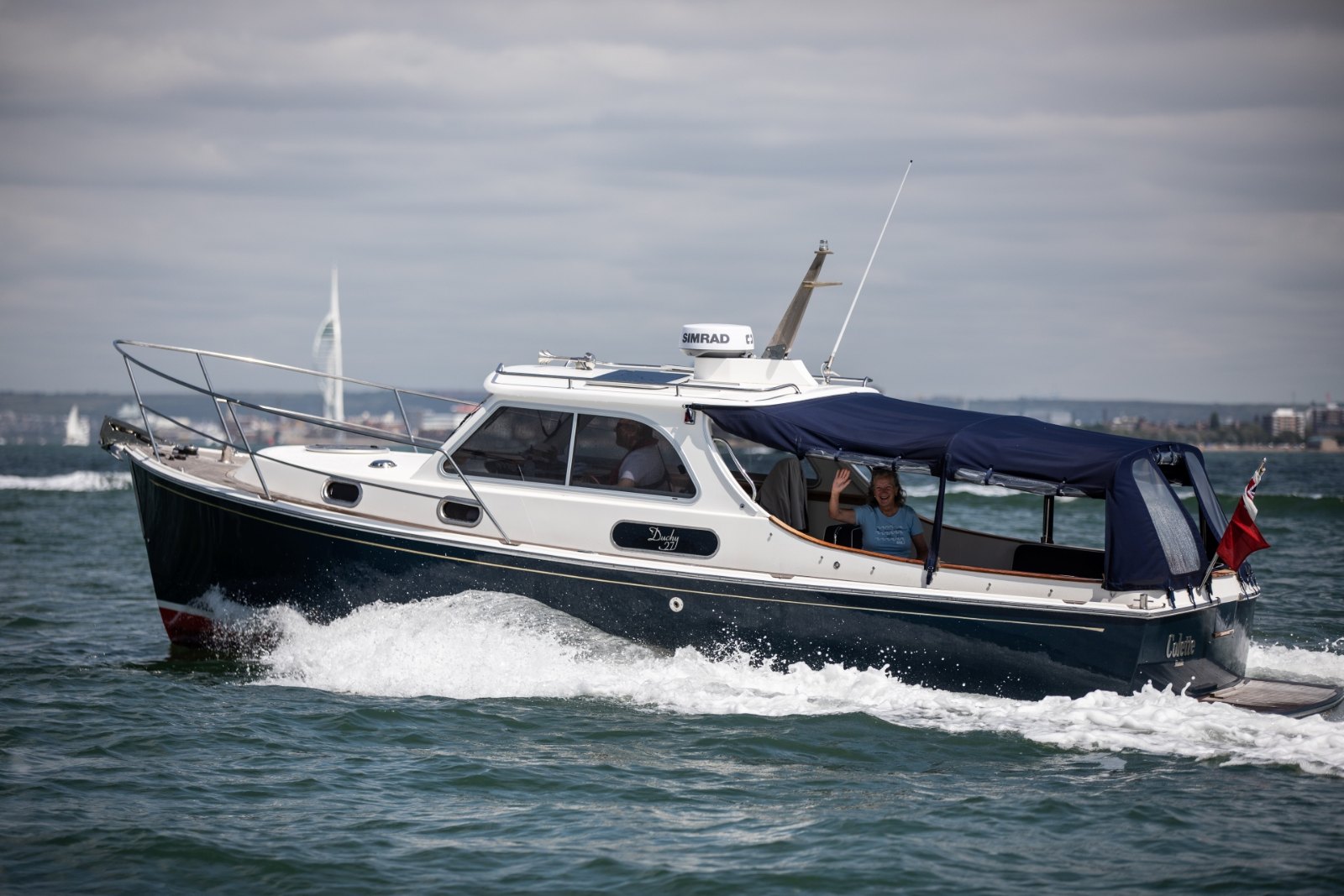 Navy-hulled Duchy 35 under way on the Solent with her cockpit canopy up during the 2024 Cockwells Owners' Rally