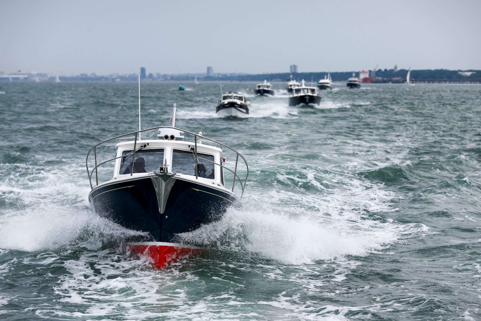 Duchy 35 motor launch at the head of the Cockwells fleet crossing the Solent during the 2025 Owners' Rally
