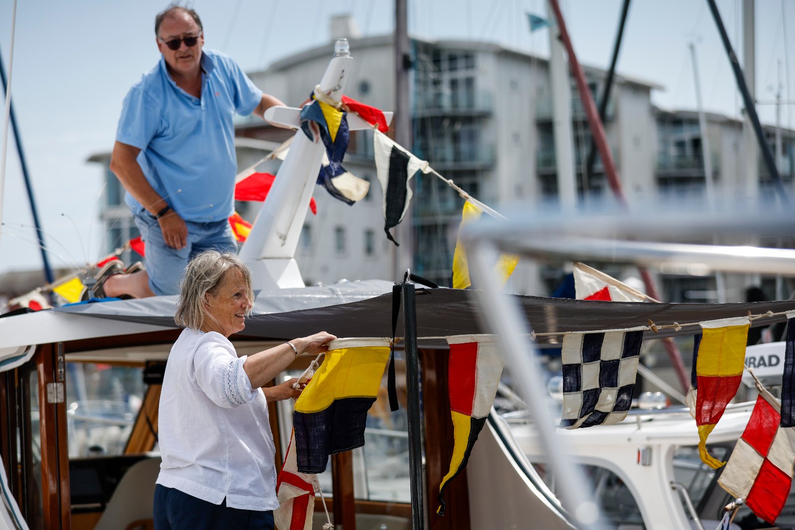 Owners dressing their Duchy motor launches with signal flags at the 2025 Cockwells Owners' Rally