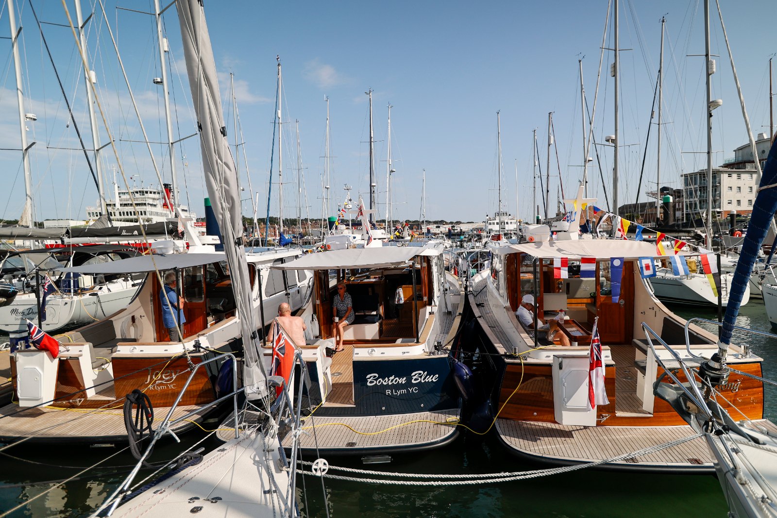 Row of Duchy 35 and Duchy 27 motor launches moored side by side at the 2025 Cockwells Owners' Rally