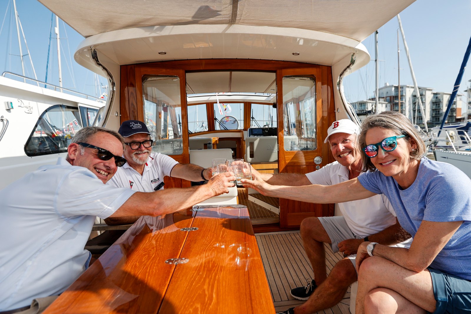 Guests enjoying drinks in the cockpit of a Duchy 35 motor launch at the 2025 Cockwells Owners' Rally